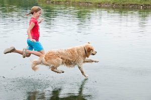 jumping in lake dog and girl